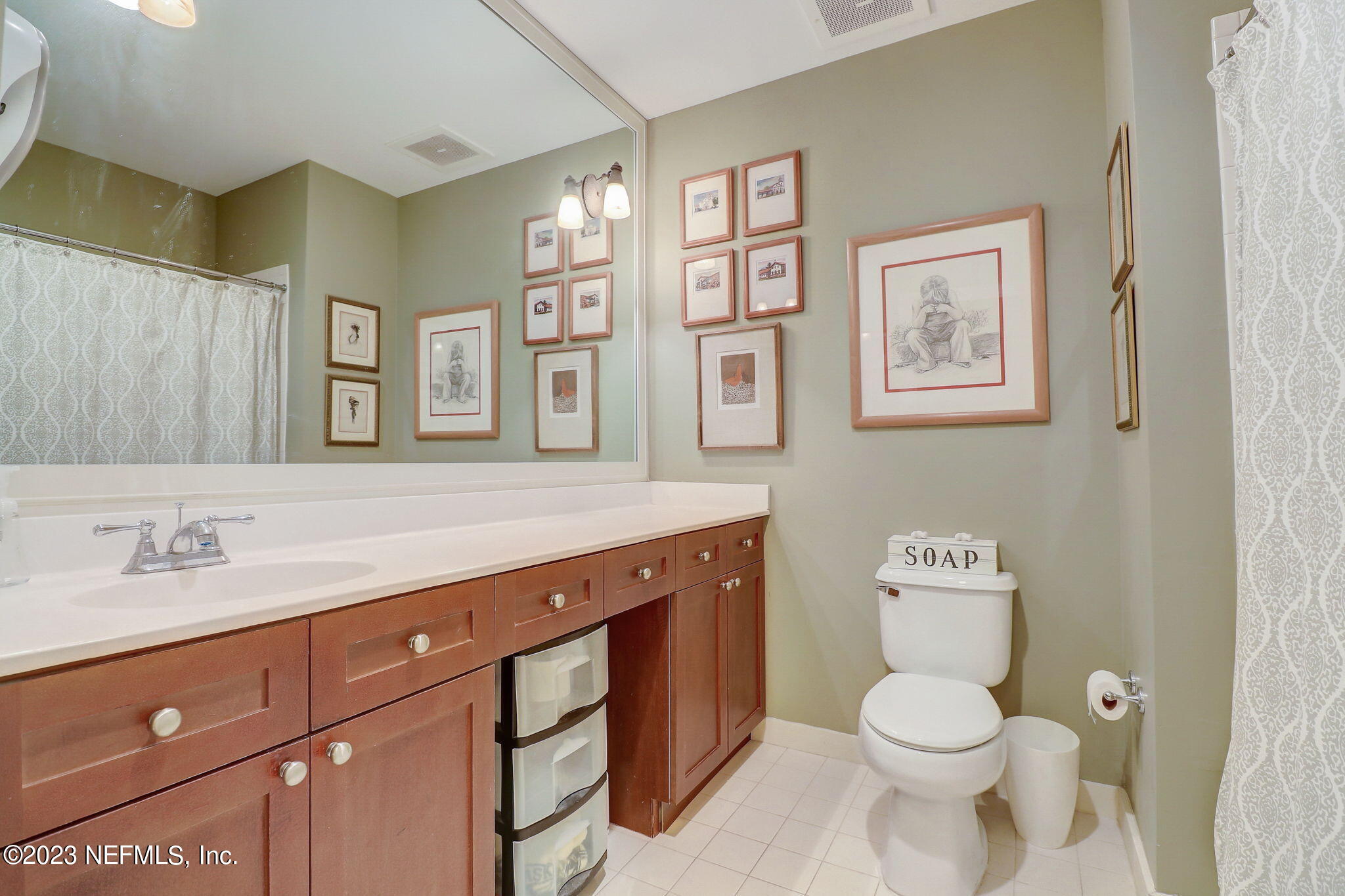 965 Registry Boulevard, Unit 307 St. Augustine, FL 32092 - Photo 14 of 31 a bathroom with a toilet sink and mirror