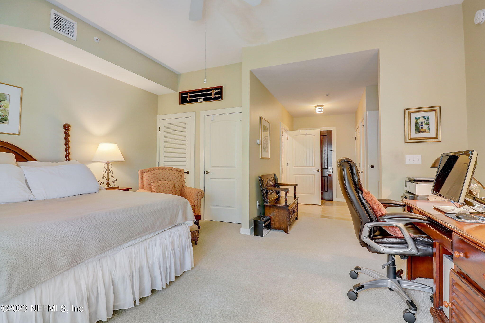 965 Registry Boulevard, Unit 307 St. Augustine, FL 32092 - Photo 16 of 31 a bedroom with a bed a desk and chair