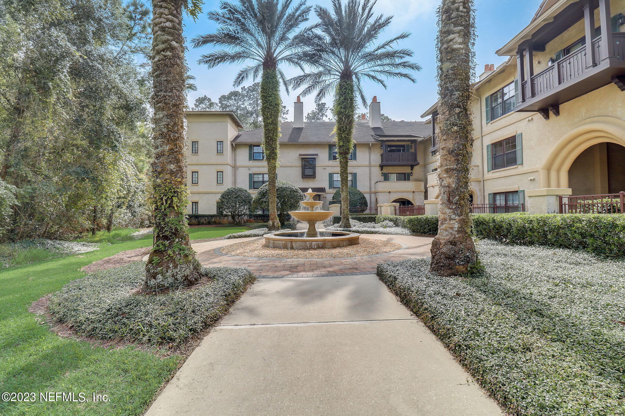 965 Registry Boulevard, Unit 307 St. Augustine, FL 32092 - Photo 18 of 31 a building exterior with tall trees