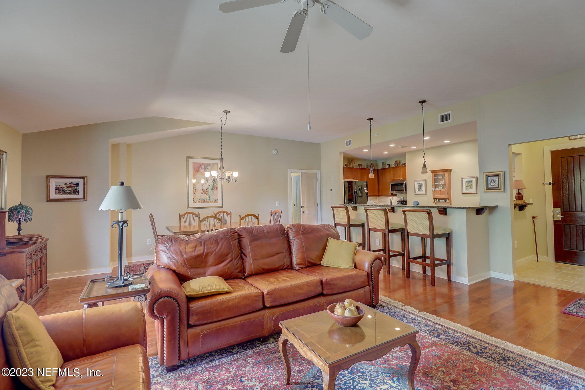 965 Registry Boulevard, Unit 307 St. Augustine, FL 32092 - Photo 4 of 31 a living room with furniture wooden floor and a kitchen view