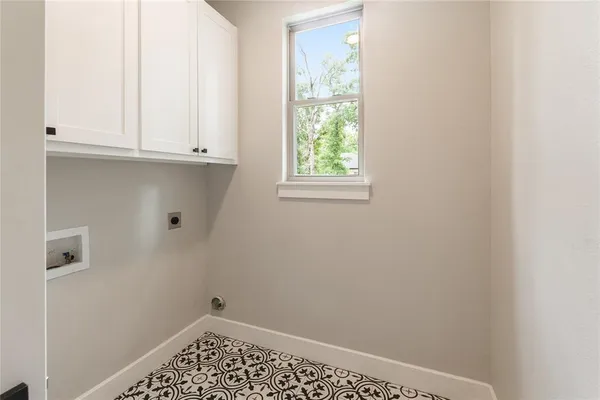 a kitchen with granite countertop a sink stainless steel appliances and window