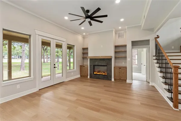 a view of an empty room with a fireplace and a large window