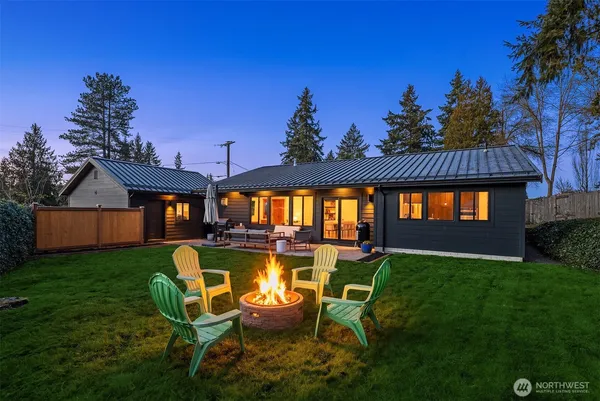 a view of a house with swimming pool and sitting area