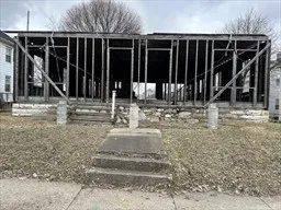 a view of small house in front of a yard