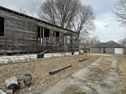 a view of a house with a yard covered in snow