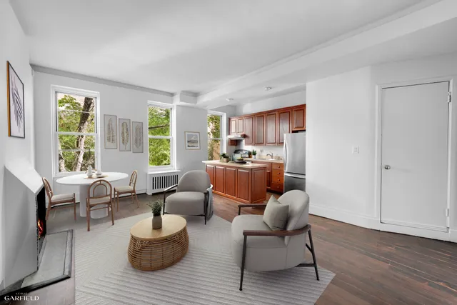 a kitchen with stainless steel appliances a sink a stove a refrigerator and cabinets