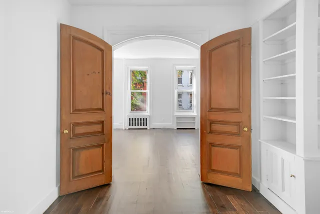 a kitchen with stainless steel appliances a stove a sink dishwasher a microwave oven and a stove with wooden floor