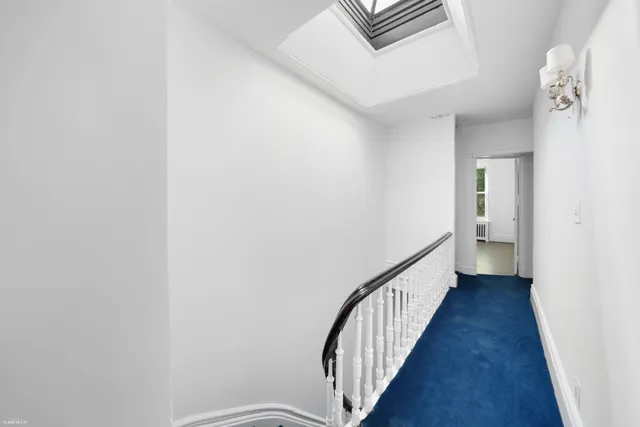 a view of an empty room with closet and wooden floor