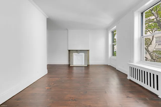 a bedroom with a large bed couch and a window