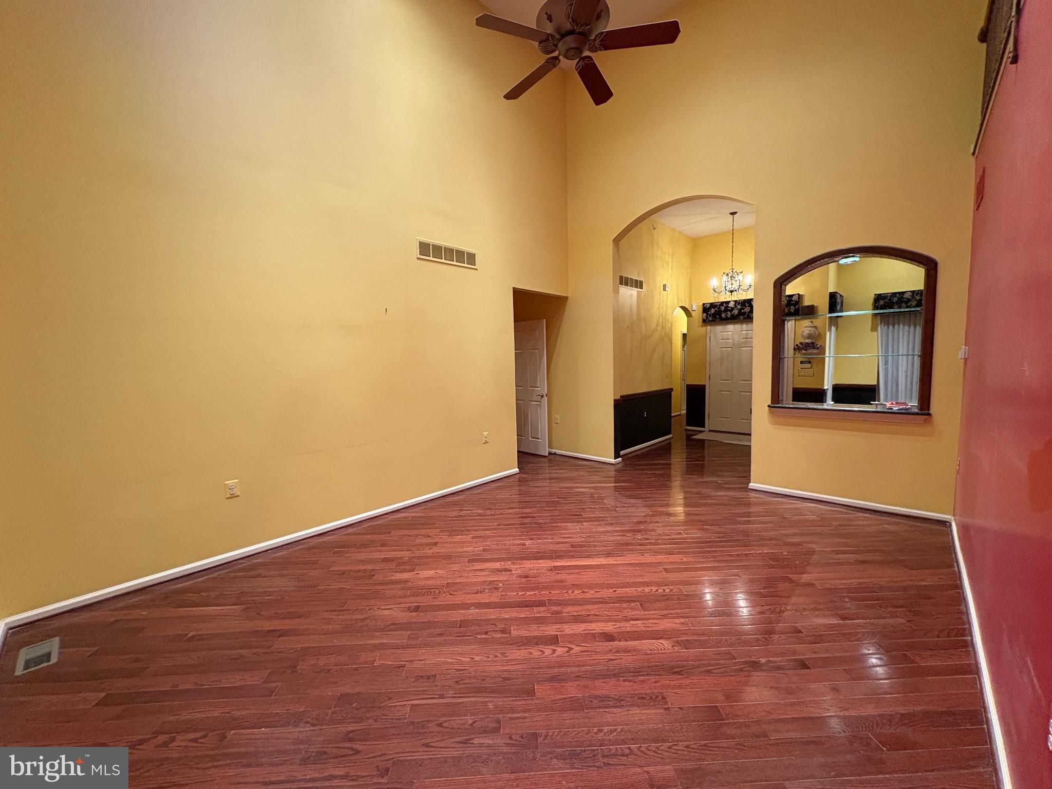 950 Nathaniel Trail Warminster, PA 18974 - Photo 9 of 66 Spacious Family Room with vibrant yellow walls.