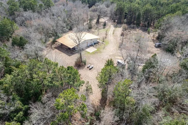 an aerial view of a house with a yard