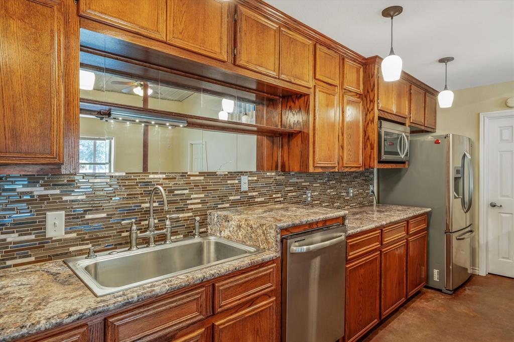 1070 Piney Grove Road Rusk, TX 75785 - Photo 13 of 39 a kitchen with stainless steel appliances granite countertop a sink and a refrigerator