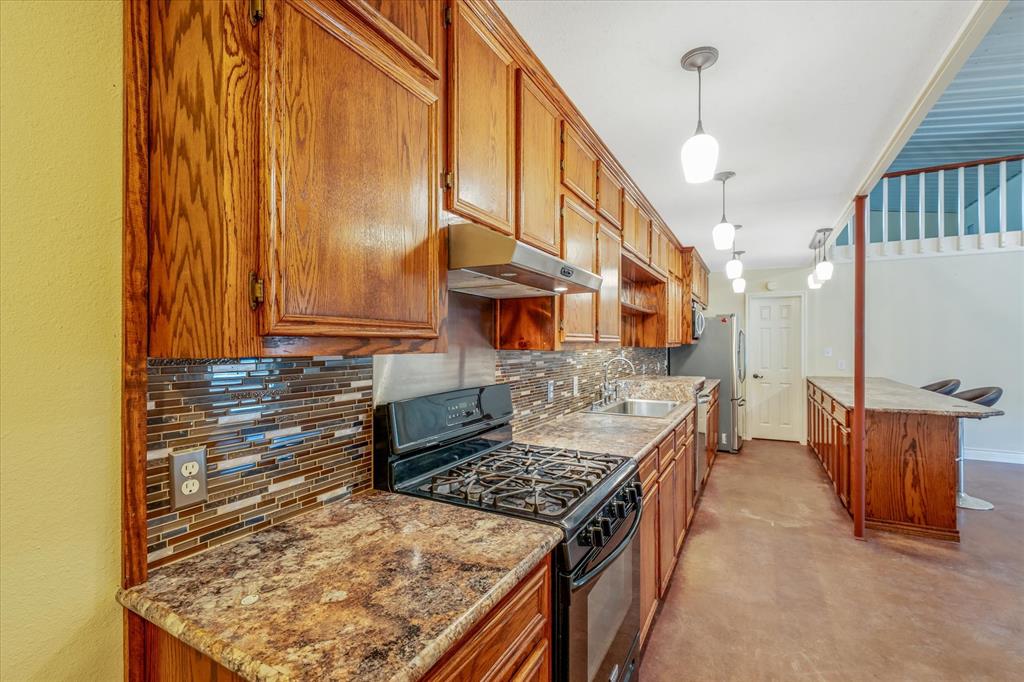 1070 Piney Grove Road Rusk, TX 75785 - Photo 14 of 39 a kitchen with stainless steel appliances granite countertop a stove a sink and a refrigerator