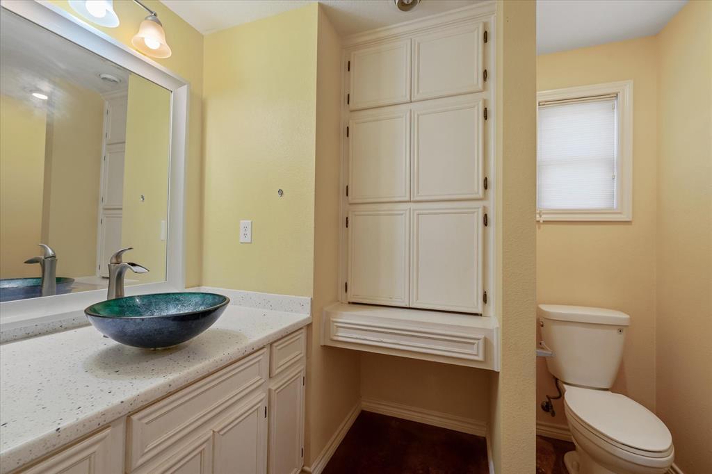 1070 Piney Grove Road Rusk, TX 75785 - Photo 18 of 39 a bathroom with a granite countertop sink toilet and a mirror