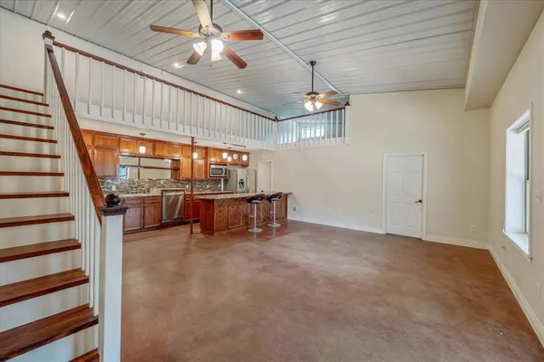 a kitchen with stainless steel appliances granite countertop a stove a sink and a refrigerator