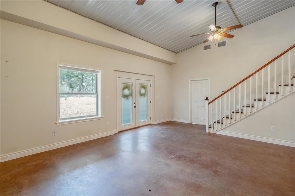 1070 Piney Grove Road Rusk, TX 75785 - Photo 10 of 39 Entryway featuring french doors, a ceiling fan, finished concrete flooring, and vaulted ceiling
