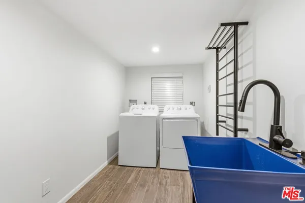 a room with a sink cabinets and wooden floor