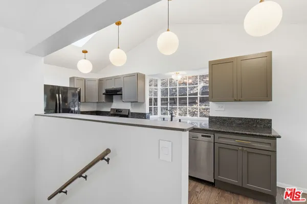 a kitchen with cabinets and window