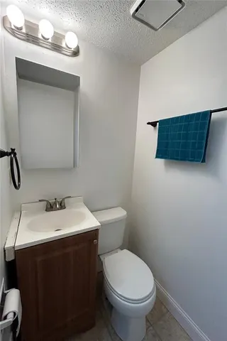 a bathroom with a sink toilet and mirror