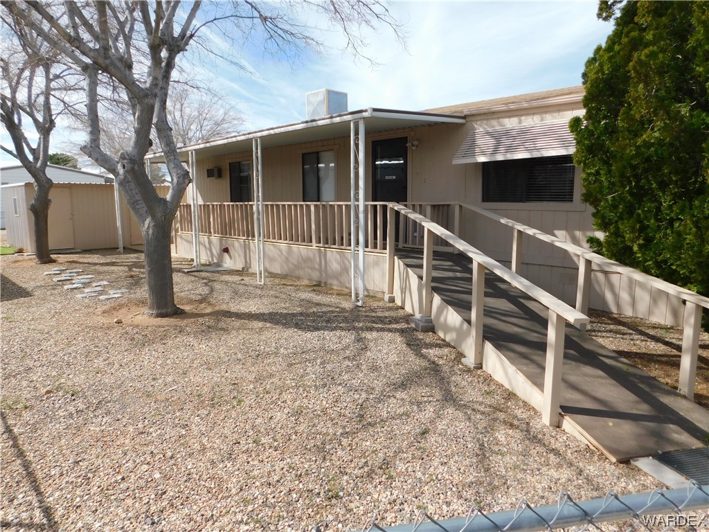 3003 Hualapai Mountain Road, Unit 55 Kingman, AZ 86401 - Photo 1 of 38 a view of a house with a yard and large tree