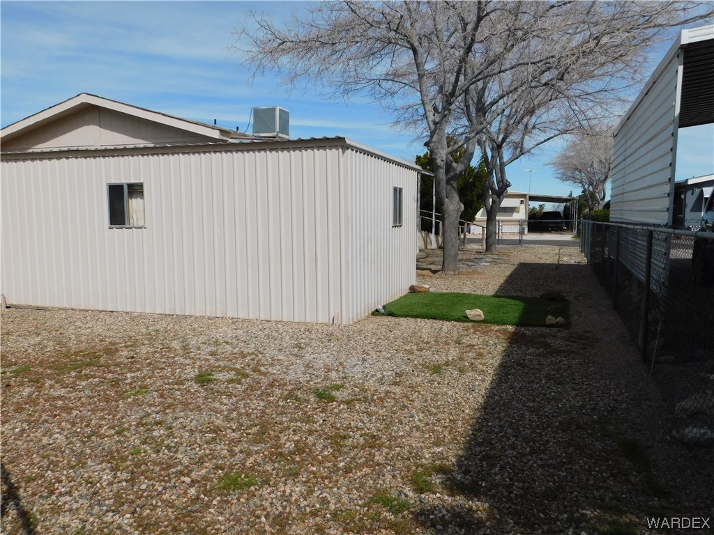 3003 Hualapai Mountain Road, Unit 55 Kingman, AZ 86401 - Photo 14 of 38 a front view of a house with a yard and garage