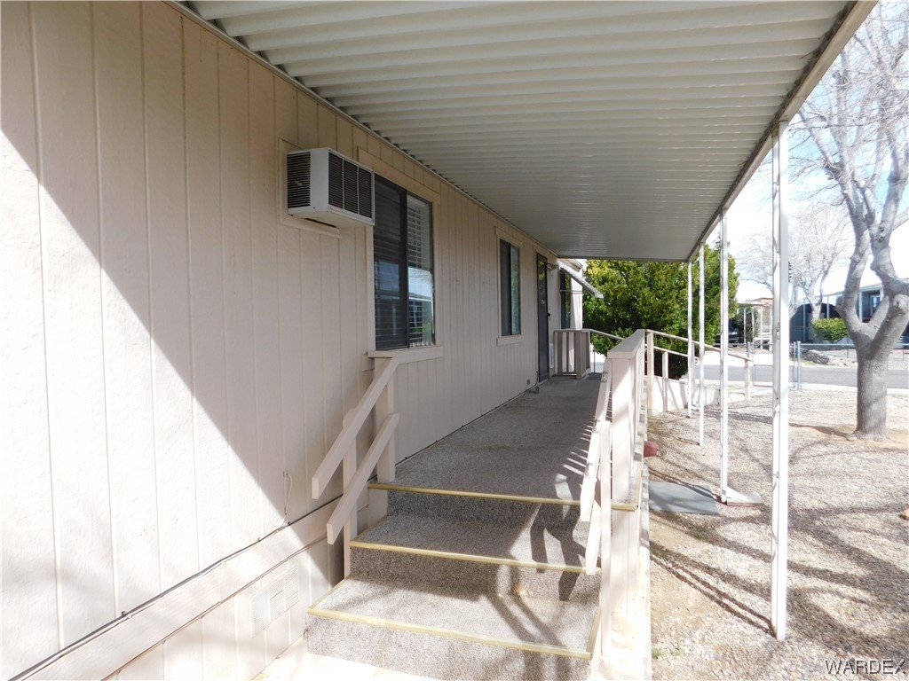 3003 Hualapai Mountain Road, Unit 55 Kingman, AZ 86401 - Photo 15 of 38 a view of a porch with wooden floor and fence