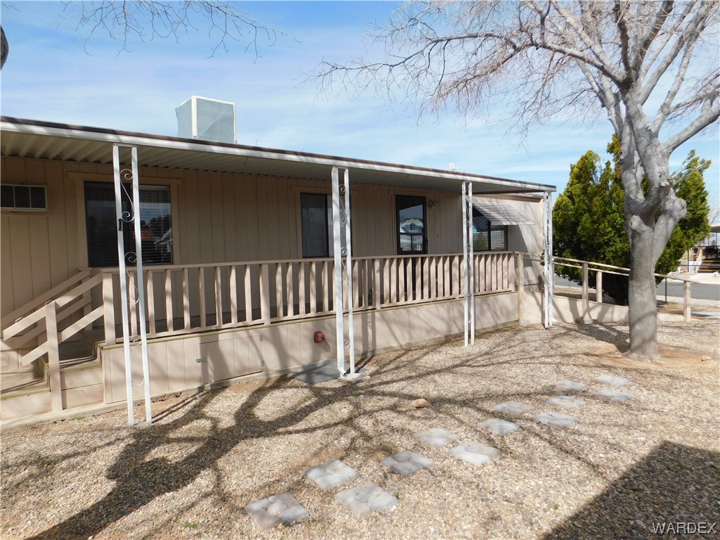 3003 Hualapai Mountain Road, Unit 55 Kingman, AZ 86401 - Photo 17 of 38 a view of a house with a wooden fence