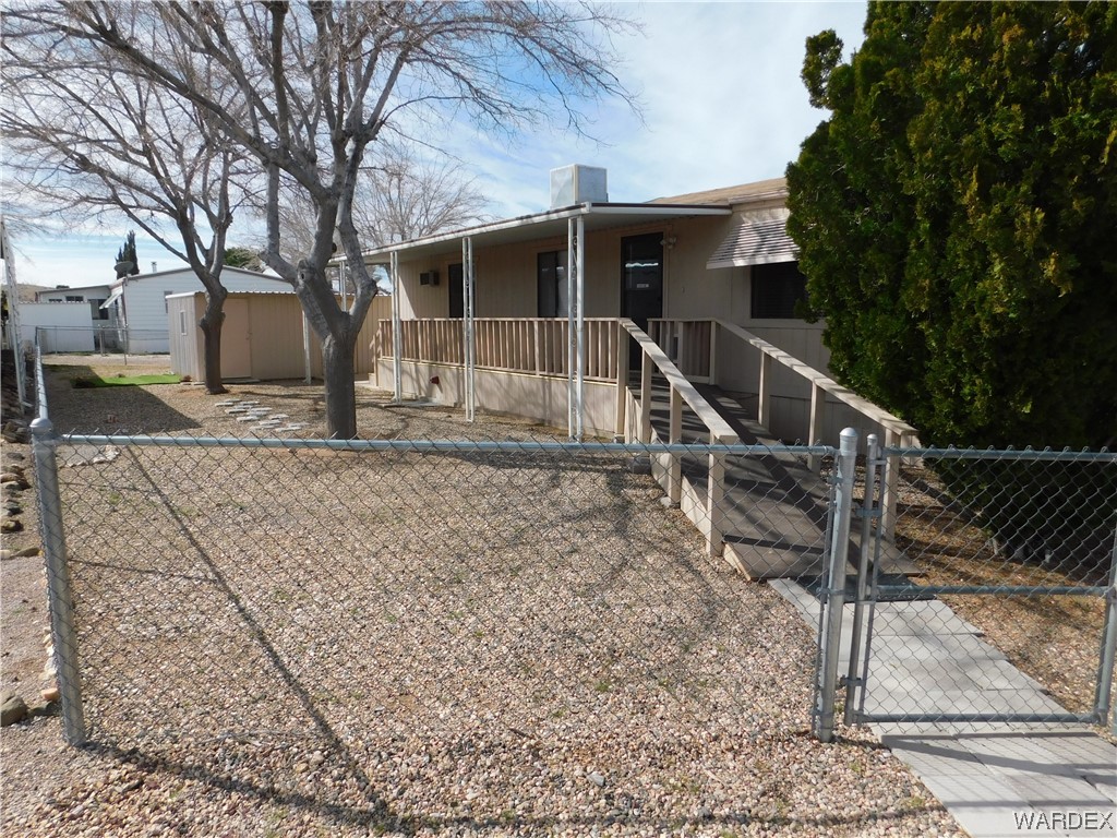 3003 Hualapai Mountain Road, Unit 55 Kingman, AZ 86401 - Photo 2 of 38 a view of a house with a yard covered with snow in the background