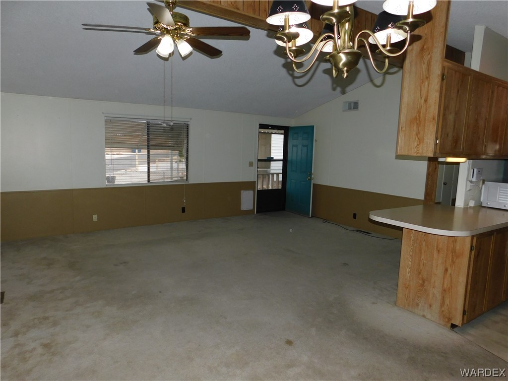 3003 Hualapai Mountain Road, Unit 55 Kingman, AZ 86401 - Photo 23 of 38 a kitchen with stainless steel appliances granite countertop a sink a stove and a wooden floors
