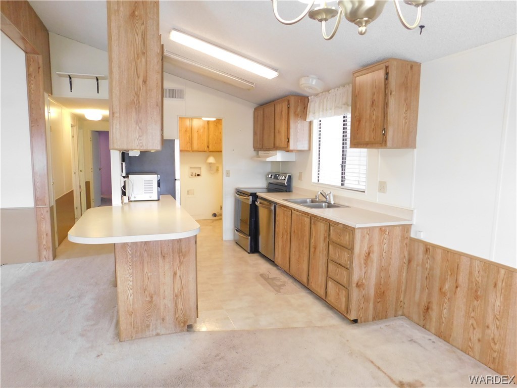 3003 Hualapai Mountain Road, Unit 55 Kingman, AZ 86401 - Photo 24 of 38 a kitchen with a sink stove and refrigerator