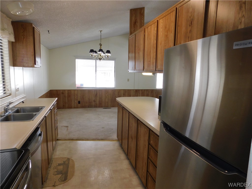 3003 Hualapai Mountain Road, Unit 55 Kingman, AZ 86401 - Photo 26 of 38 a kitchen with a refrigerator and a sink