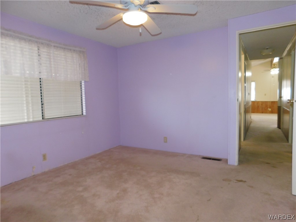 3003 Hualapai Mountain Road, Unit 55 Kingman, AZ 86401 - Photo 30 of 38 en empty room with fan
