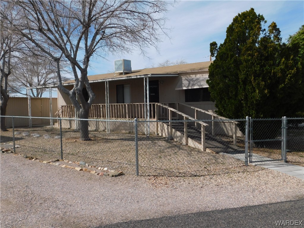 3003 Hualapai Mountain Road, Unit 55 Kingman, AZ 86401 - Photo 3 of 38 a backyard of a house with lots of trees and the swing