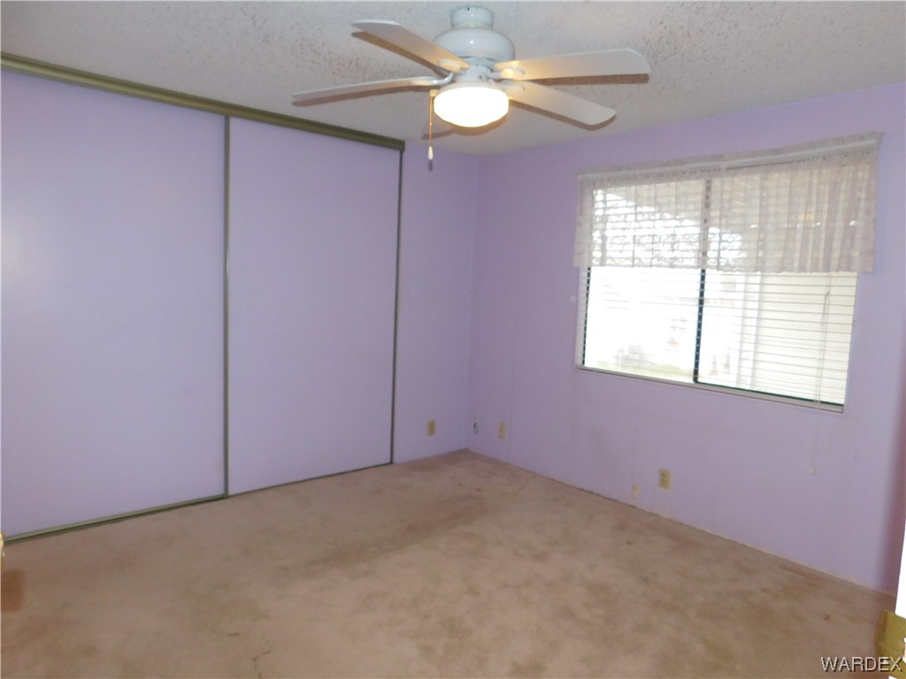 3003 Hualapai Mountain Road, Unit 55 Kingman, AZ 86401 - Photo 31 of 38 an empty room with a window and a fan