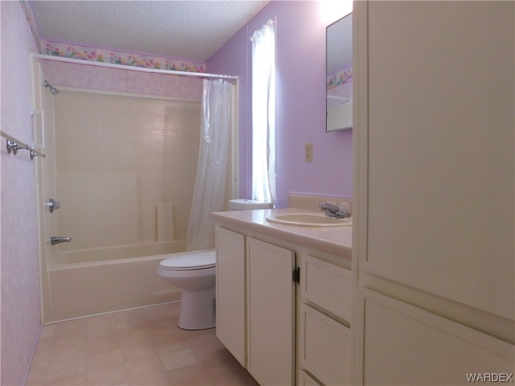 3003 Hualapai Mountain Road, Unit 55 Kingman, AZ 86401 - Photo 32 of 38 a bathroom with a granite countertop sink toilet and shower
