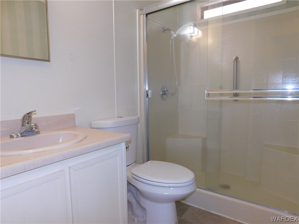 3003 Hualapai Mountain Road, Unit 55 Kingman, AZ 86401 - Photo 37 of 38 a bathroom with a sink a toilet and shower