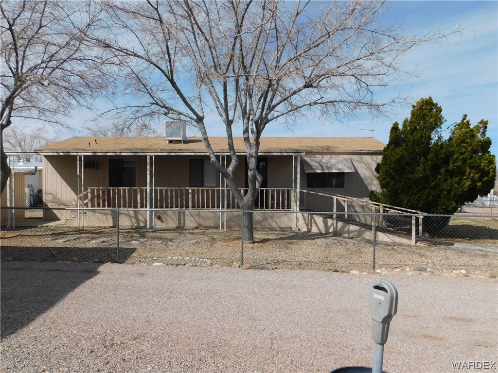 3003 Hualapai Mountain Road, Unit 55 Kingman, AZ 86401 - Photo 4 of 38 a view of a house with wooden fence