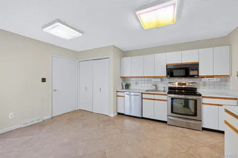 a kitchen with a stove top oven and sink