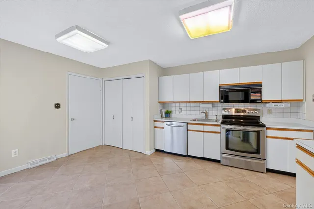 a kitchen with a stove top oven and sink