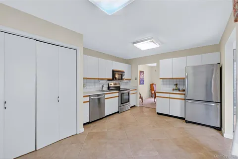 a kitchen with granite countertop cabinets and stainless steel appliances