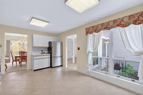 a kitchen with refrigerator and cabinets