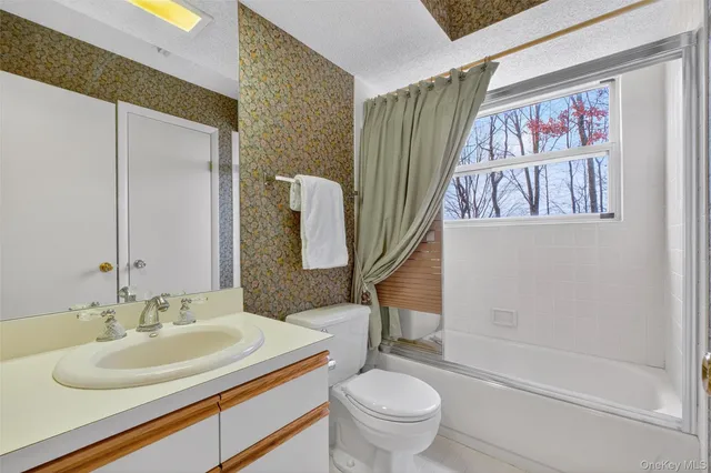 a view of a livingroom with furniture and a window