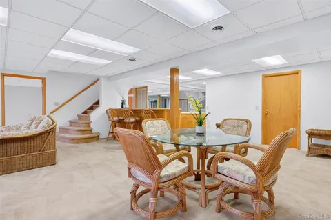 a bathroom with a sink a toilet and a large mirror