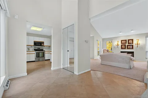 a view of a livingroom with furniture and an empty room