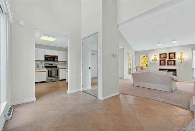 a view of a livingroom with furniture and an empty room