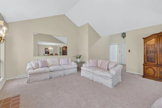 a living room with furniture white walls and white walls