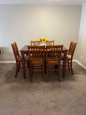 a view of a dining room with furniture and a chandelier