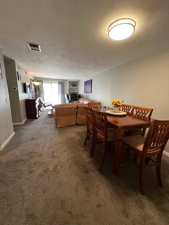 a livingroom with furniture and a dining table