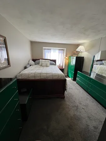 a bedroom with a bed and window