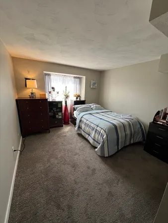 a bedroom with bed and window